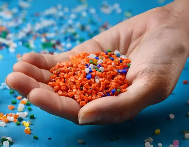quality consistency in chemical supply shown with uniform plastic pellets in hand